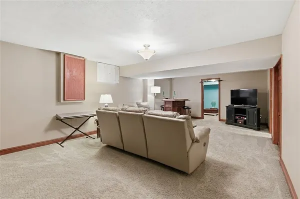 a bathroom with a granite countertop sink mirror vanity and toilet