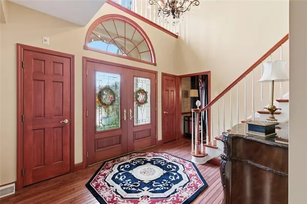 a view of entryway with a rug wooden floor and a rug