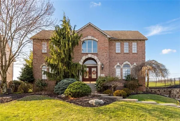 an aerial view of a house with garden space and street view
