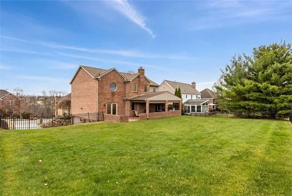 an aerial view of a house with garden space and street view