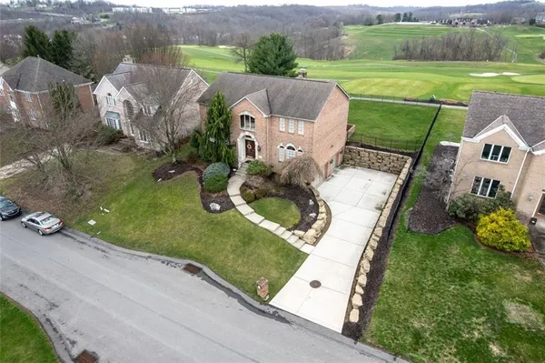 an aerial view of a house with a garden and swimming pool