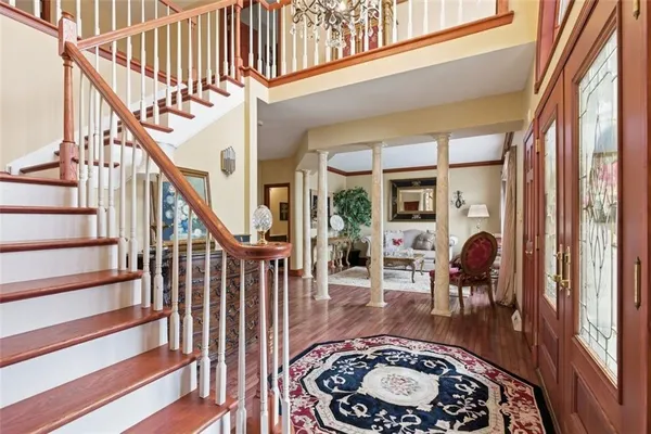 a view of a hallway with a dining table and chairs