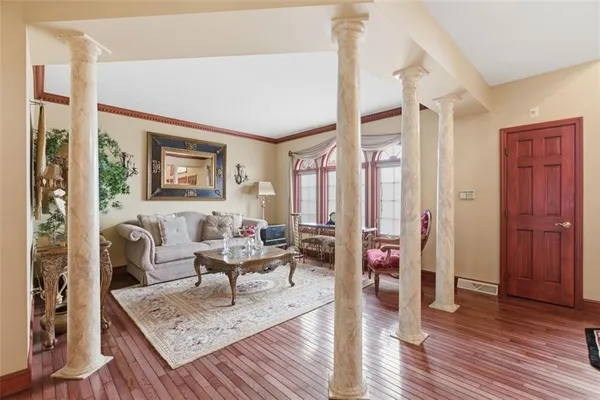 a living room with furniture and wooden floor