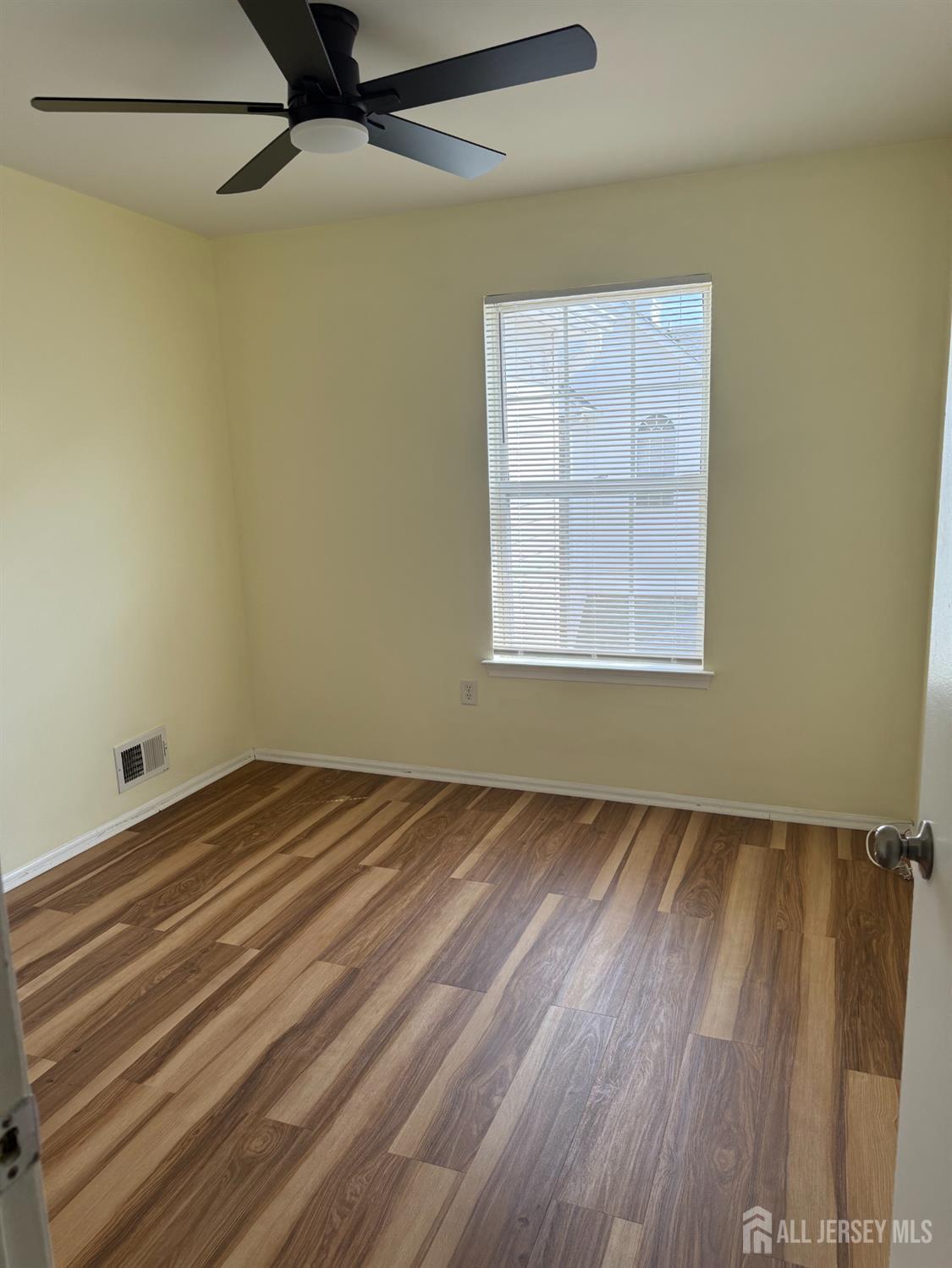 813 Plymouth Road North Brunswick, NJ 08902 - Photo 11 of 14 a view of a room with wooden floor and a window