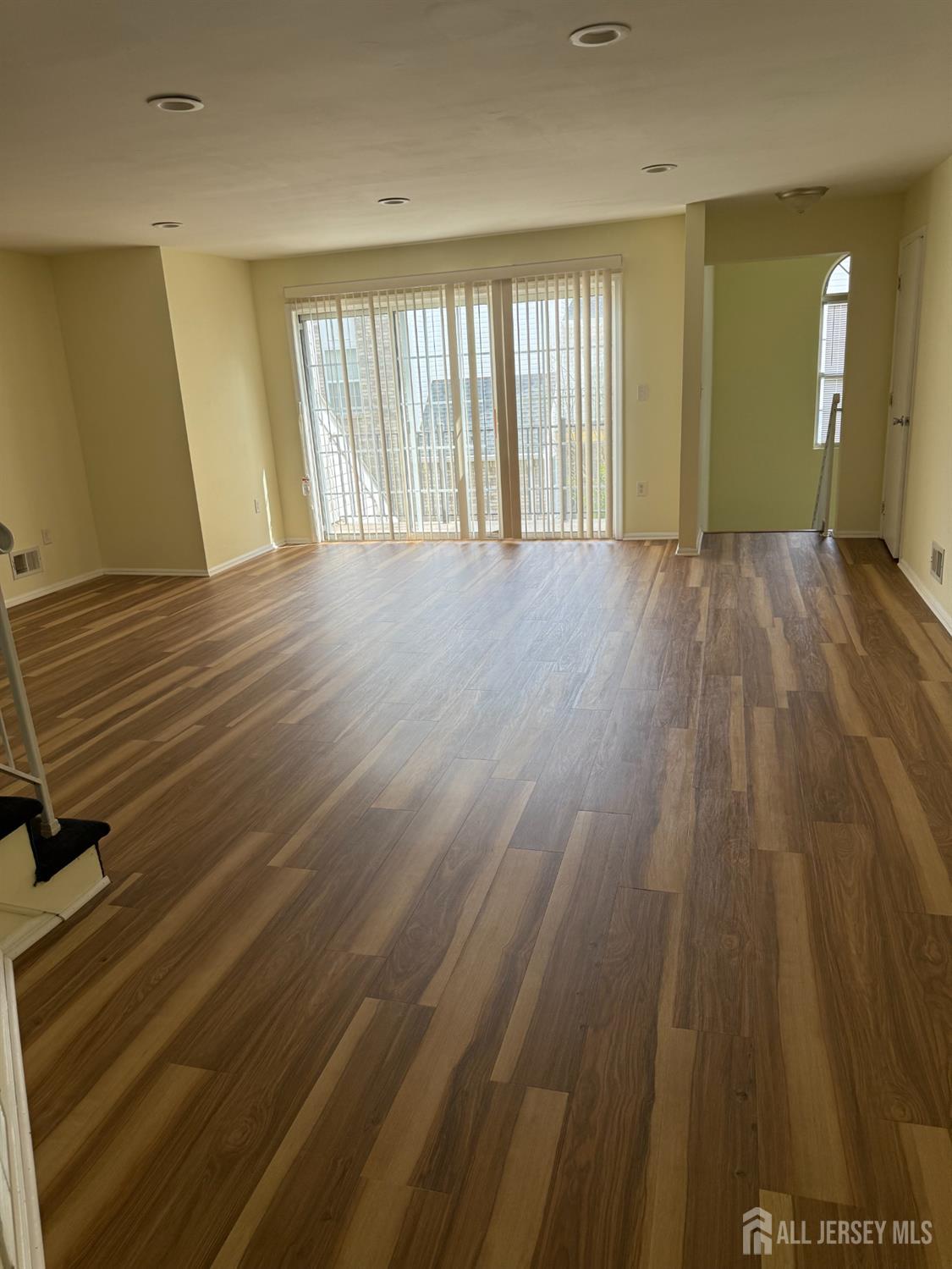813 Plymouth Road North Brunswick, NJ 08902 - Photo 5 of 14 wooden floor in an empty room with a window