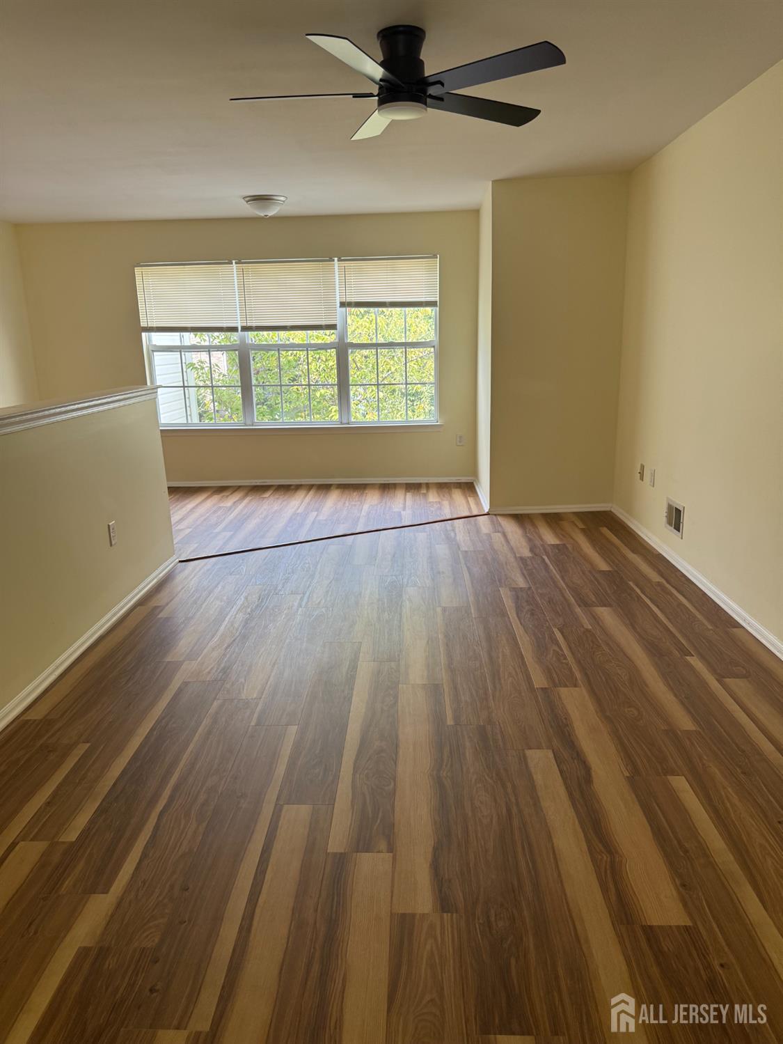 813 Plymouth Road North Brunswick, NJ 08902 - Photo 7 of 14 wooden floor in an empty room with a window
