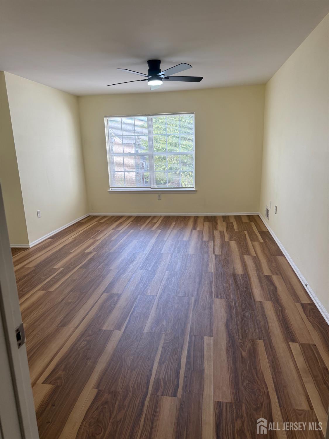 813 Plymouth Road North Brunswick, NJ 08902 - Photo 8 of 14 an empty room with wooden floor and windows
