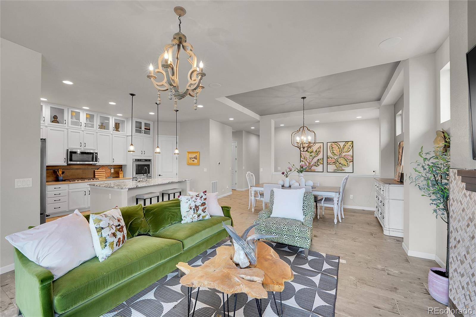 a living room with furniture and a chandelier