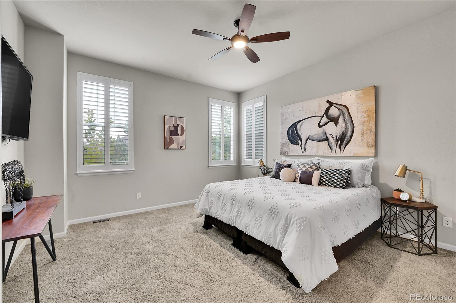 3429 Goodyear Street Castle Rock, CO 80109 - Photo 11 of 32 a bedroom with a bed and a chandelier