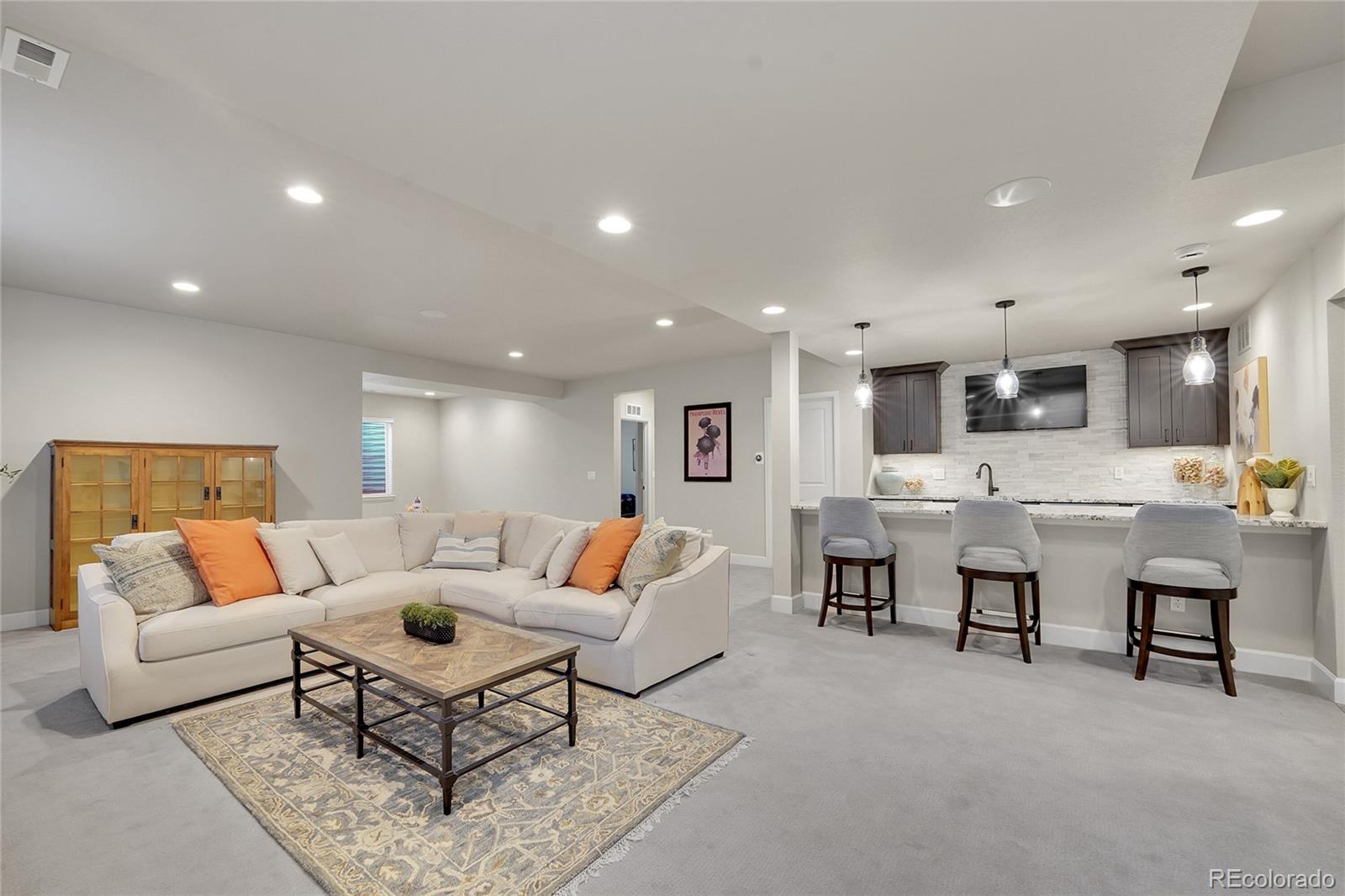 3429 Goodyear Street Castle Rock, CO 80109 - Photo 18 of 32 a living room with furniture and kitchen view