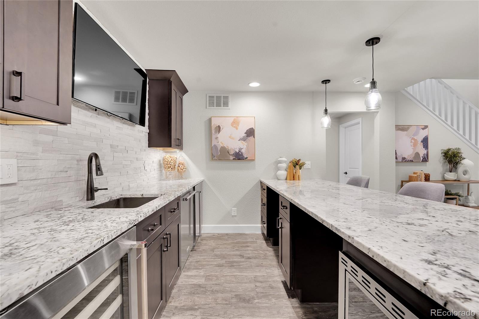 3429 Goodyear Street Castle Rock, CO 80109 - Photo 20 of 32 a kitchen with stainless steel appliances granite countertop a sink stove and cabinets