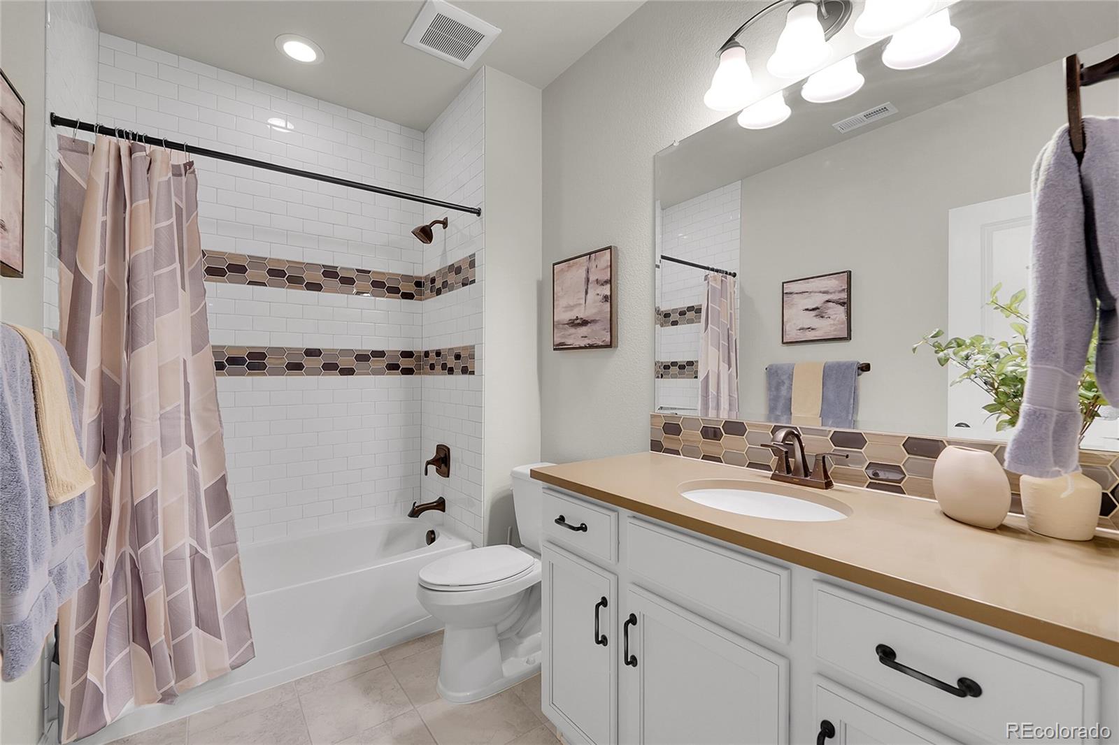 3429 Goodyear Street Castle Rock, CO 80109 - Photo 22 of 32 a bathroom with a double vanity sink mirror double vanity and bathtub