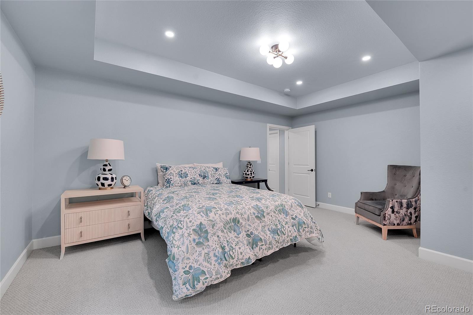 3429 Goodyear Street Castle Rock, CO 80109 - Photo 23 of 32 a bedroom with a bed and a chandelier