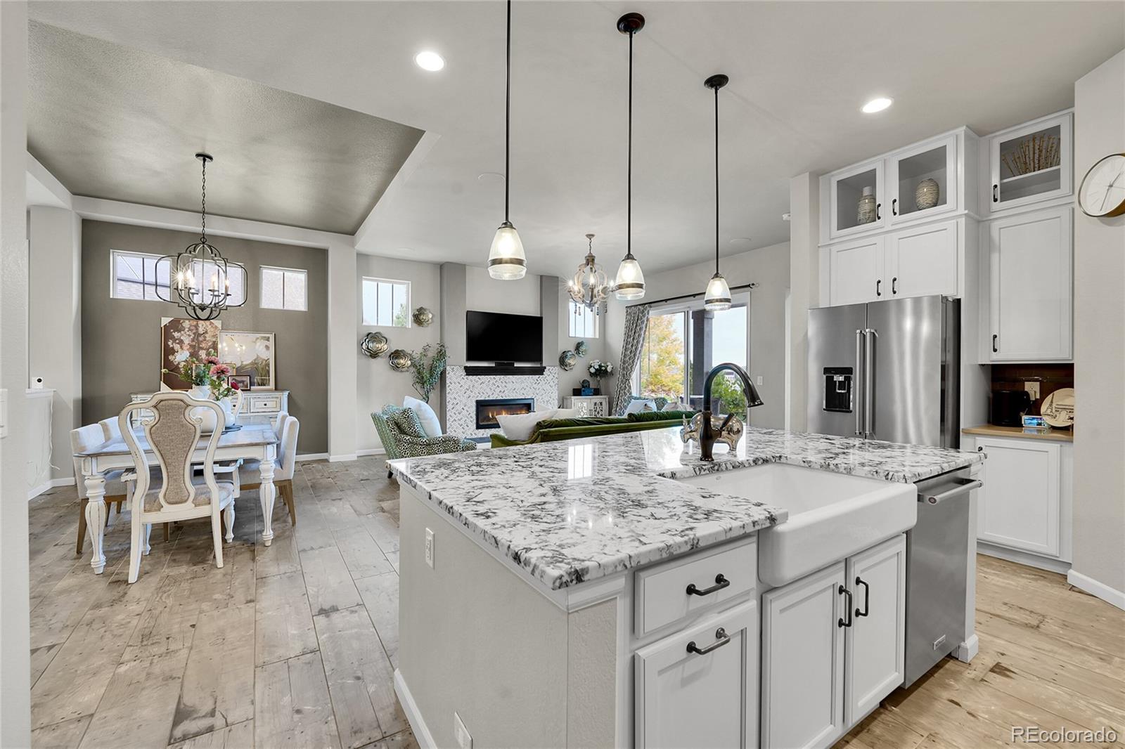 3429 Goodyear Street Castle Rock, CO 80109 - Photo 9 of 32 a kitchen with stainless steel appliances granite countertop stove top oven a sink and a refrigerator