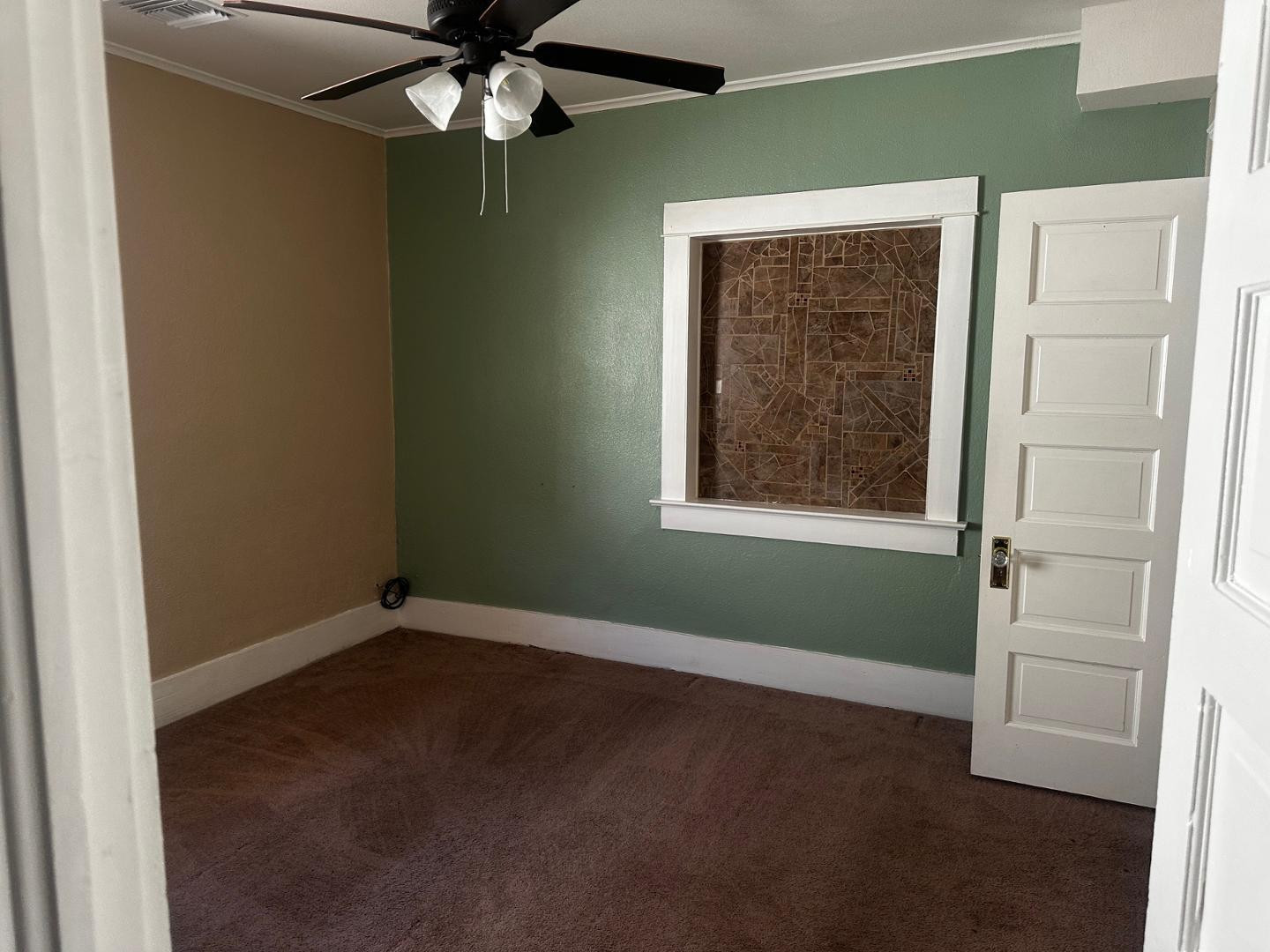 703 East 13th Street Douglas, AZ 85607 - Photo 13 of 16 an empty room with ceiling fan and window