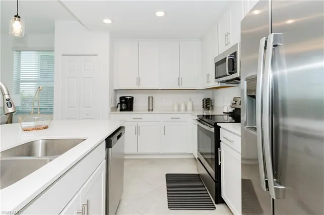 a kitchen with a sink cabinets and stainless steel appliances