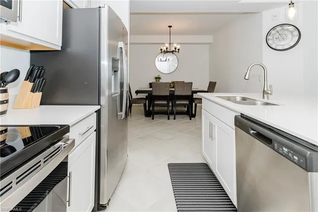 a kitchen with a sink stainless steel appliances and cabinets