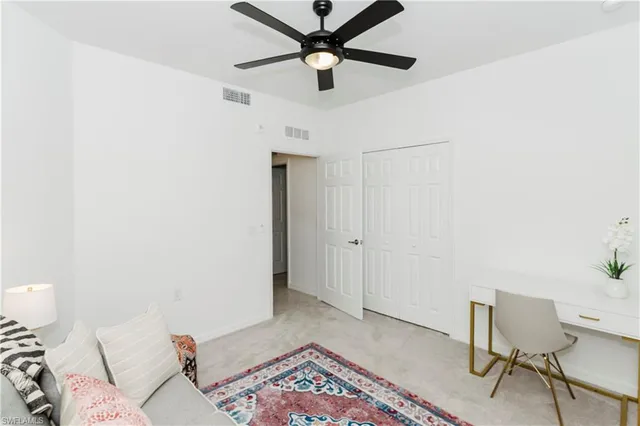 a living room with a bed and a rug