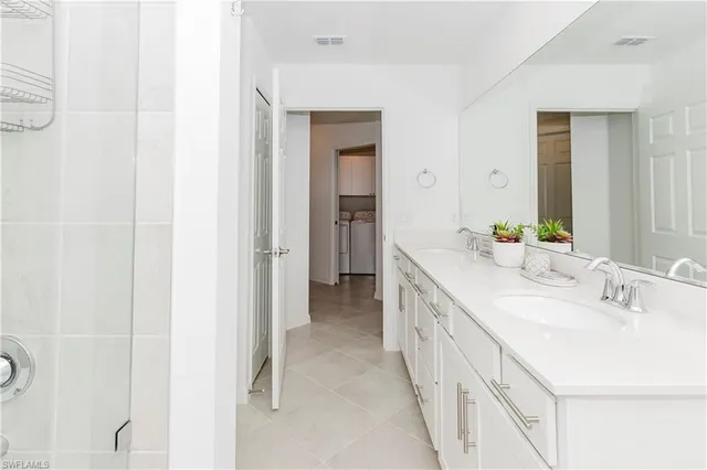 a bathroom with a double vanity sink and mirror