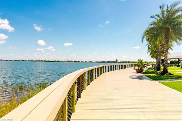 a view of swimming pool with outdoor seating and lake