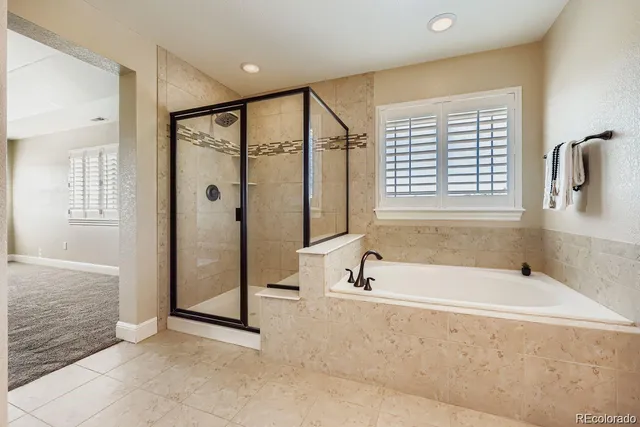 a spacious bathroom with a bathtub and a shower