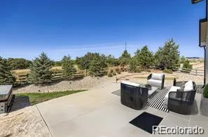 a view of a patio with couches table and chairs and floor to ceiling window