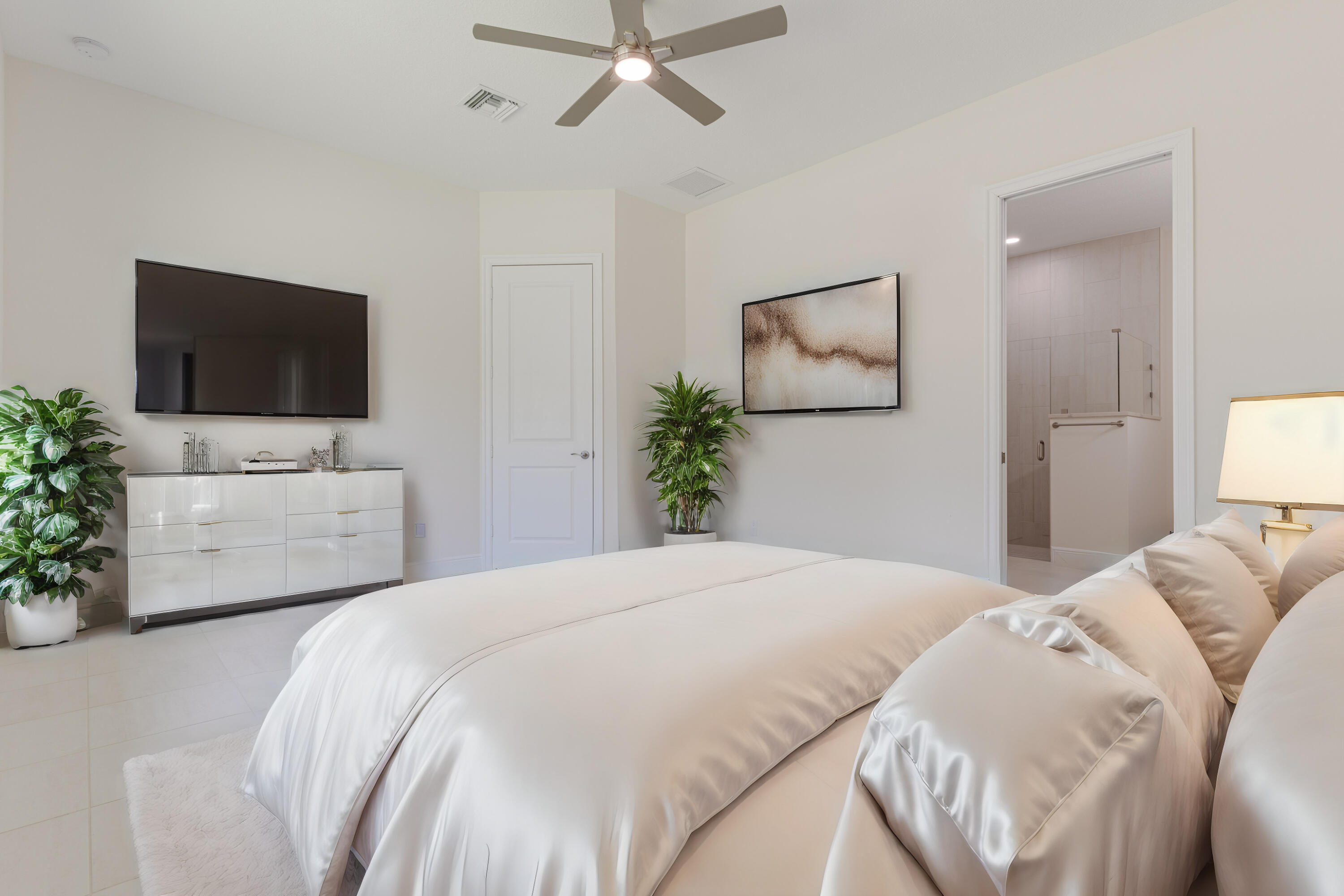 2005 Bridgepointe Circle, Unit 98 Vero Beach, FL 32967 - Photo 12 of 31 a bedroom with a balcony a bed and a flat screen tv