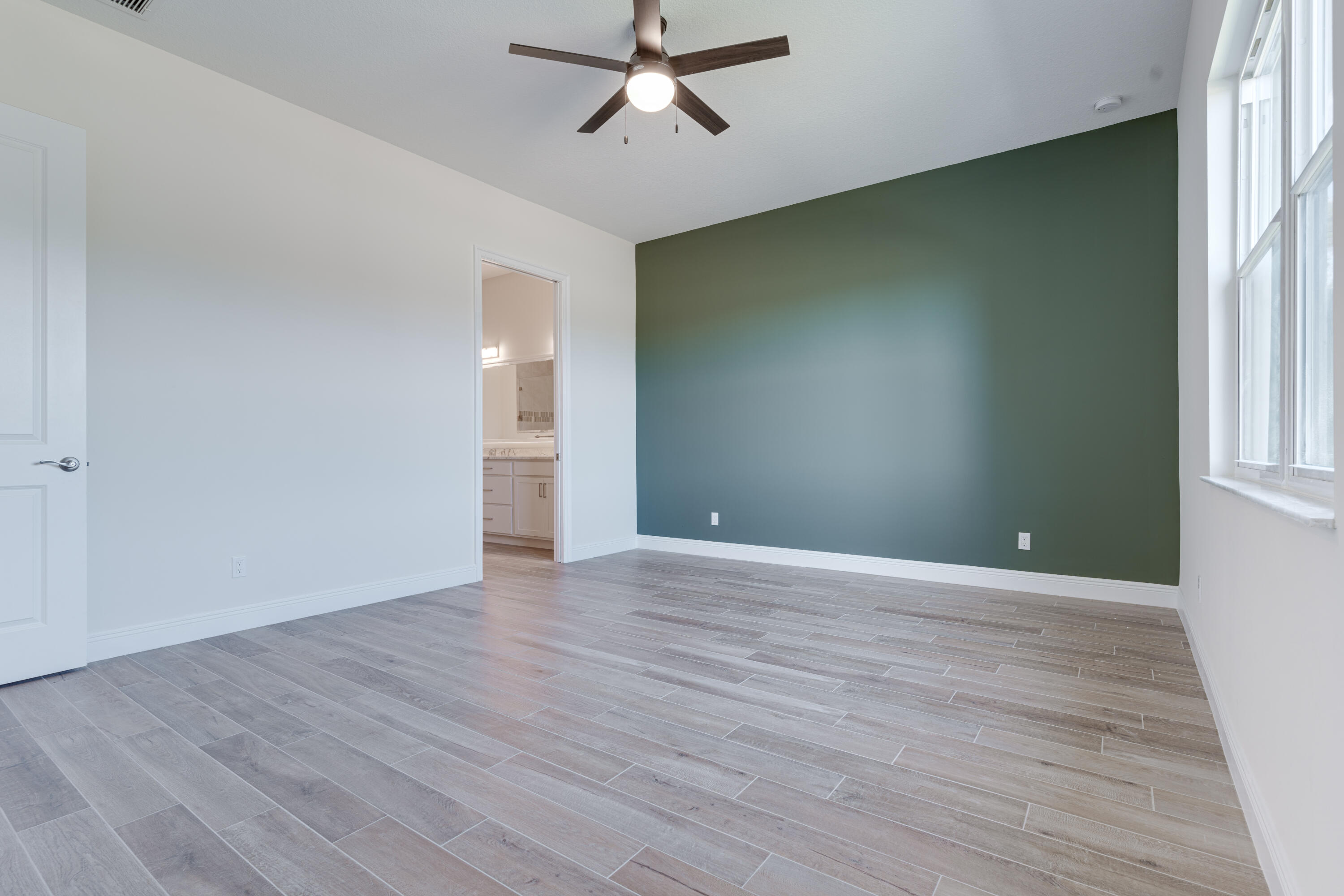 2005 Bridgepointe Circle, Unit 98 Vero Beach, FL 32967 - Photo 16 of 44 wooden floor in an empty room with a window