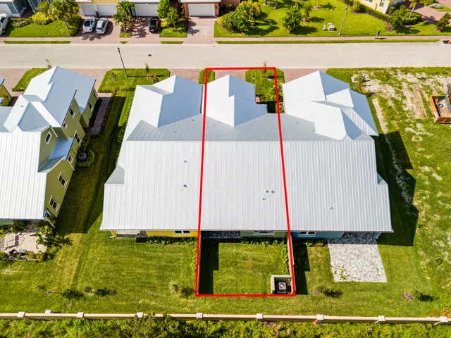 an aerial view of a house with a garden and swimming pool
