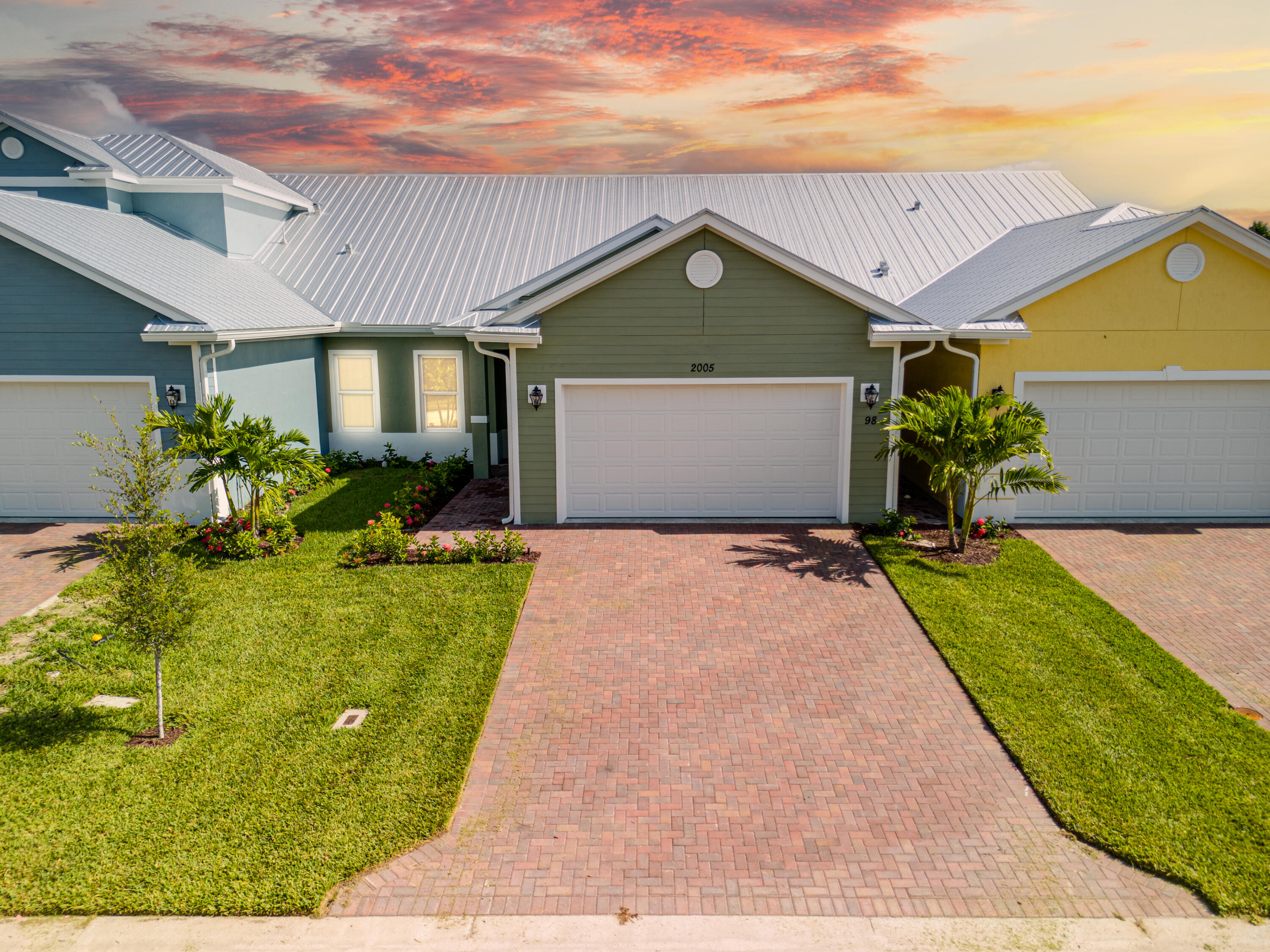 2005 Bridgepointe Circle, Unit 98 Vero Beach, FL 32967 - Photo 33 of 44 a front view of a house with a yard and potted plants