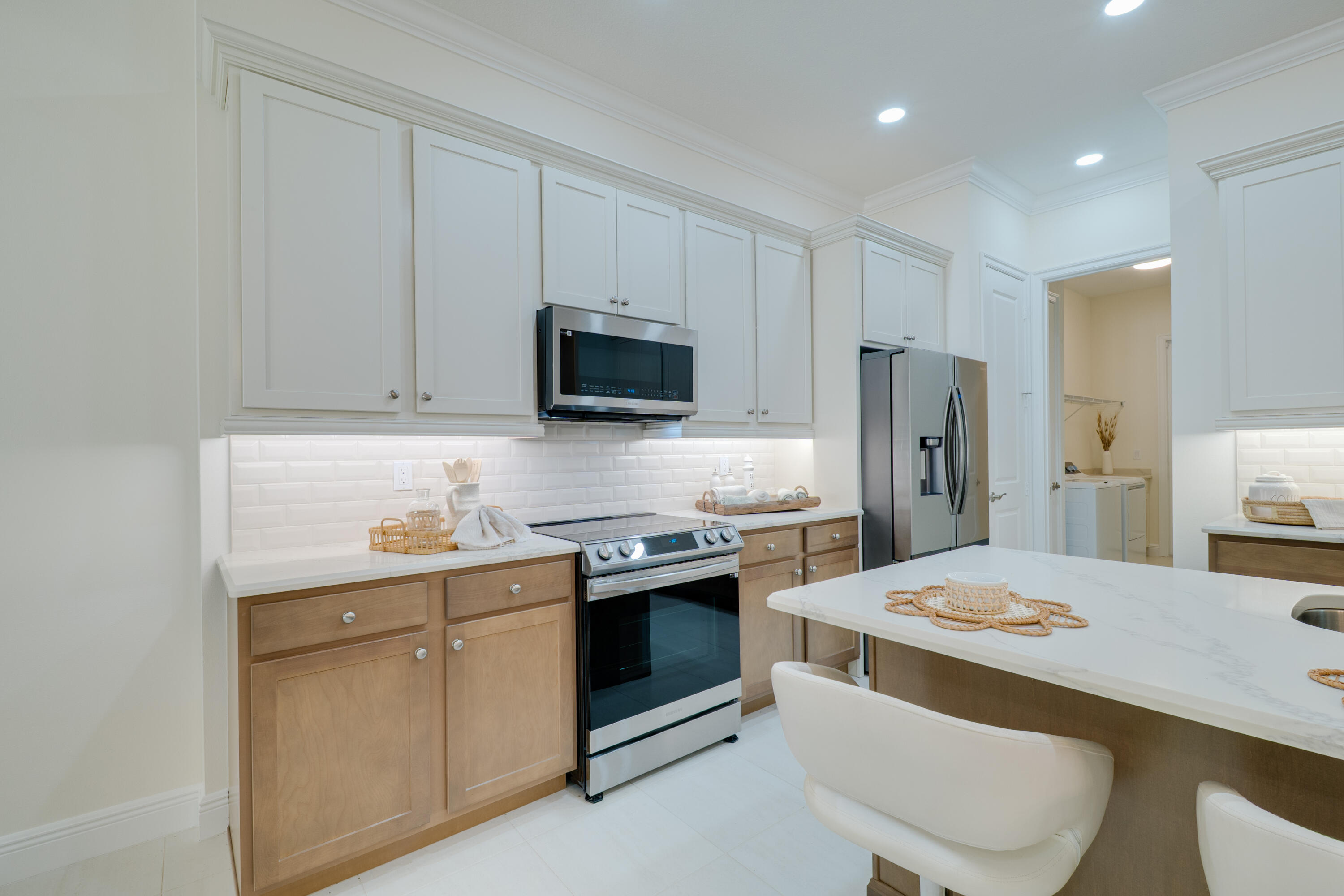 2005 Bridgepointe Circle, Unit 98 Vero Beach, FL 32967 - Photo 4 of 44 a kitchen with a sink a stove a refrigerator and cabinets
