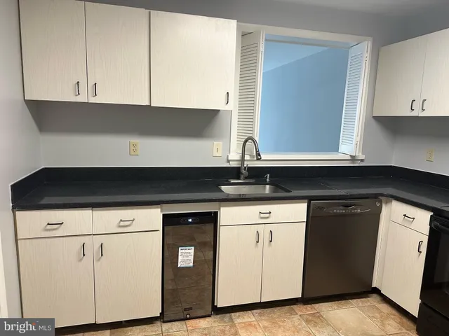 a kitchen with stainless steel appliances granite countertop a refrigerator and a stove