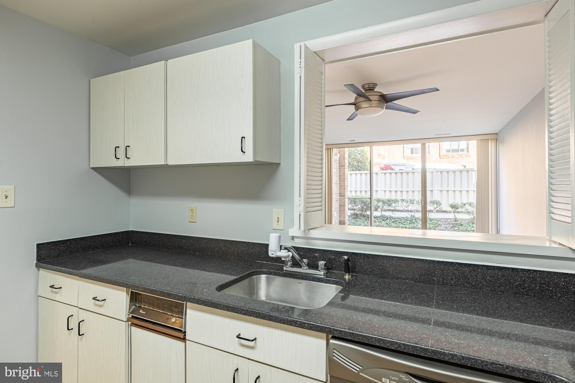 1765 South Hayes Street, Unit A Arlington, VA 22202 - Photo 15 of 21 a kitchen with granite countertop white cabinets and a sink