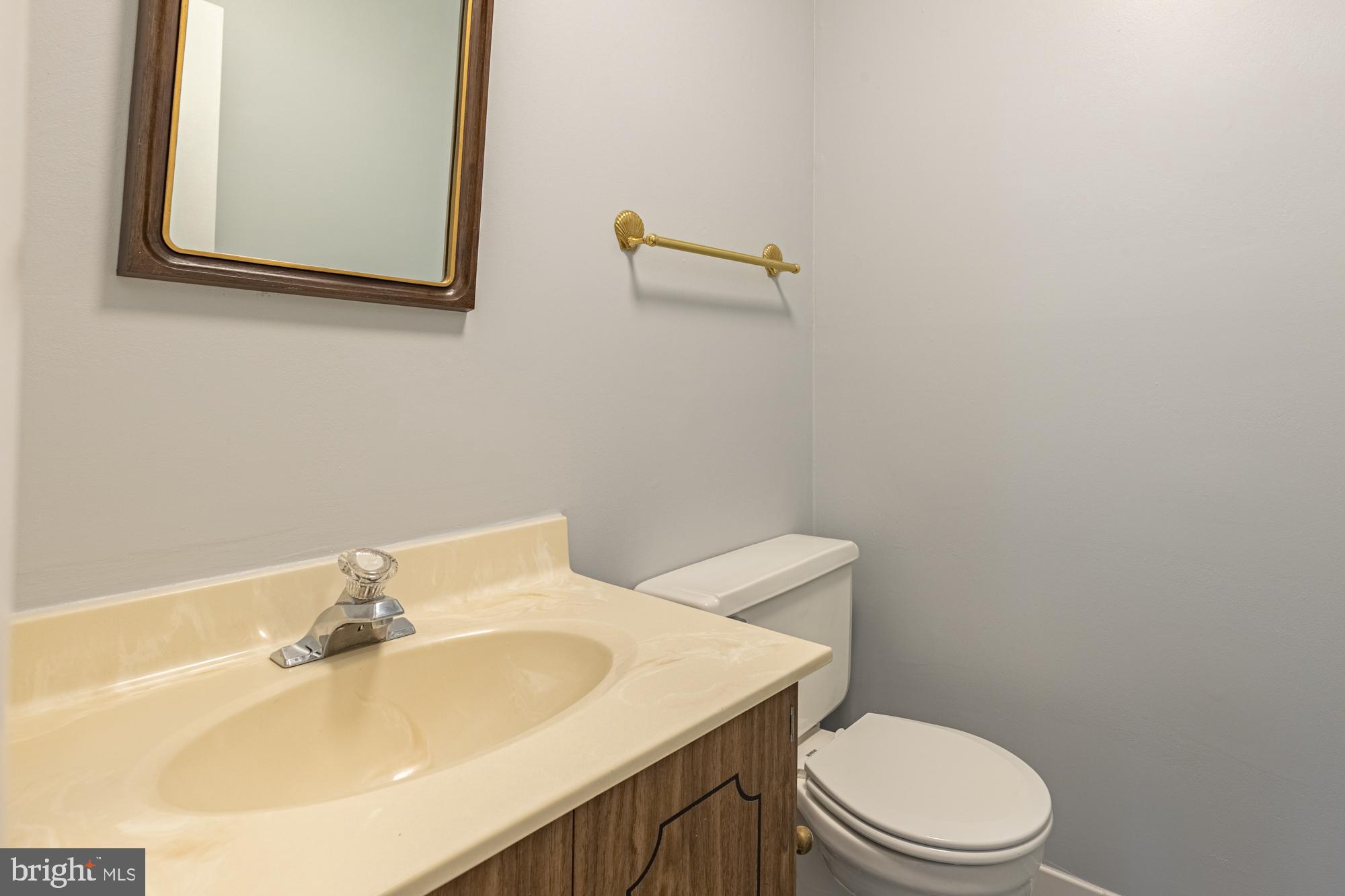 1765 South Hayes Street, Unit A Arlington, VA 22202 - Photo 16 of 21 a bathroom with a sink a toilet and mirror