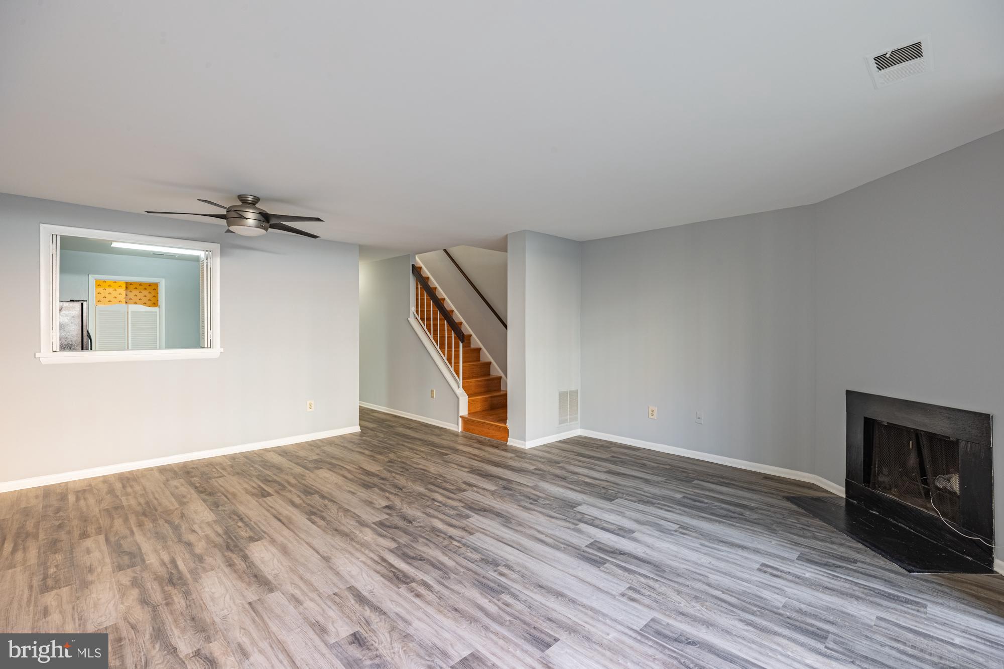 1765 South Hayes Street, Unit A Arlington, VA 22202 - Photo 19 of 21 a view of an empty room with wooden floor and a fireplace