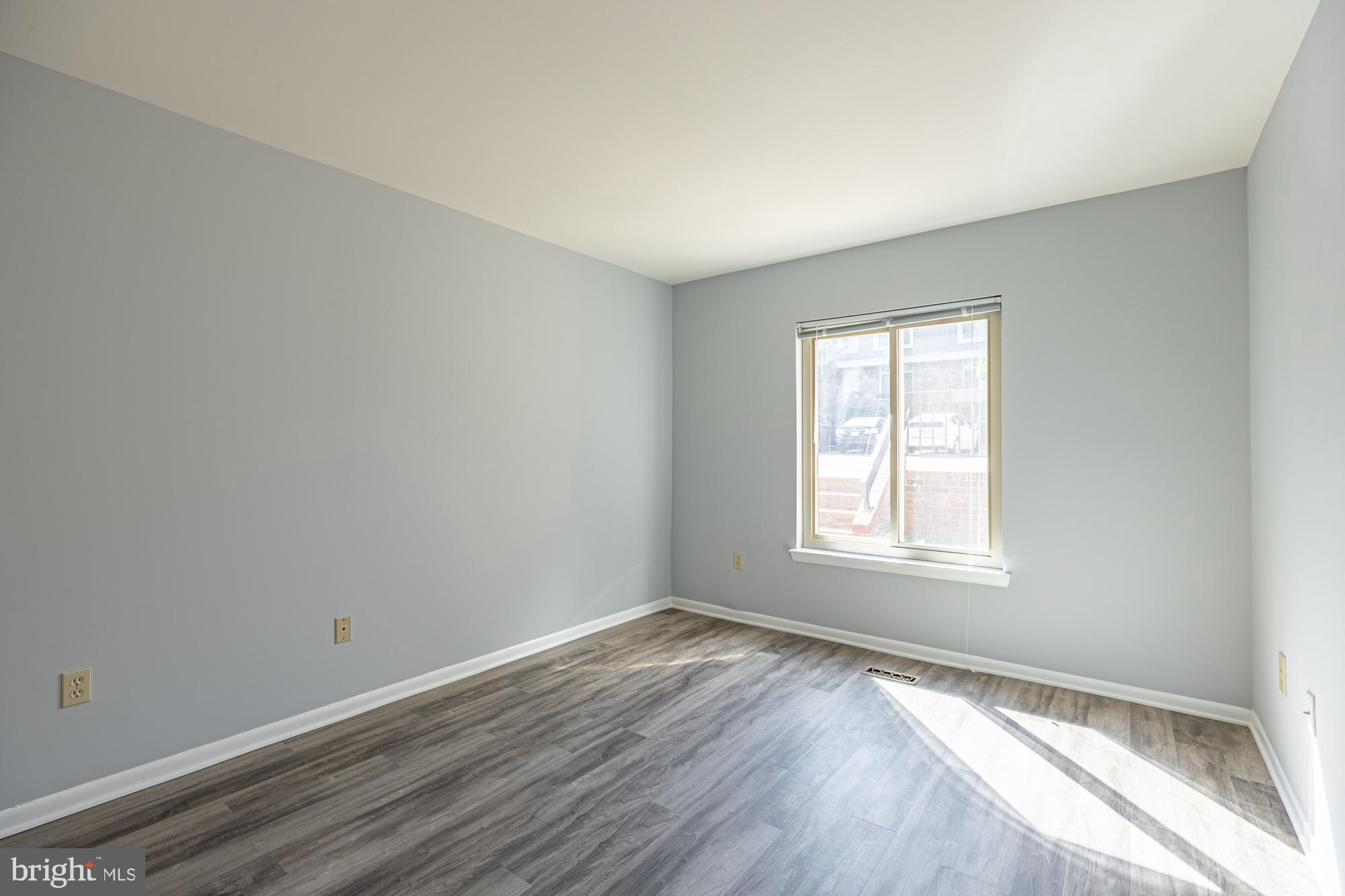 1765 South Hayes Street, Unit A Arlington, VA 22202 - Photo 7 of 21 an empty room with wooden floor and windows