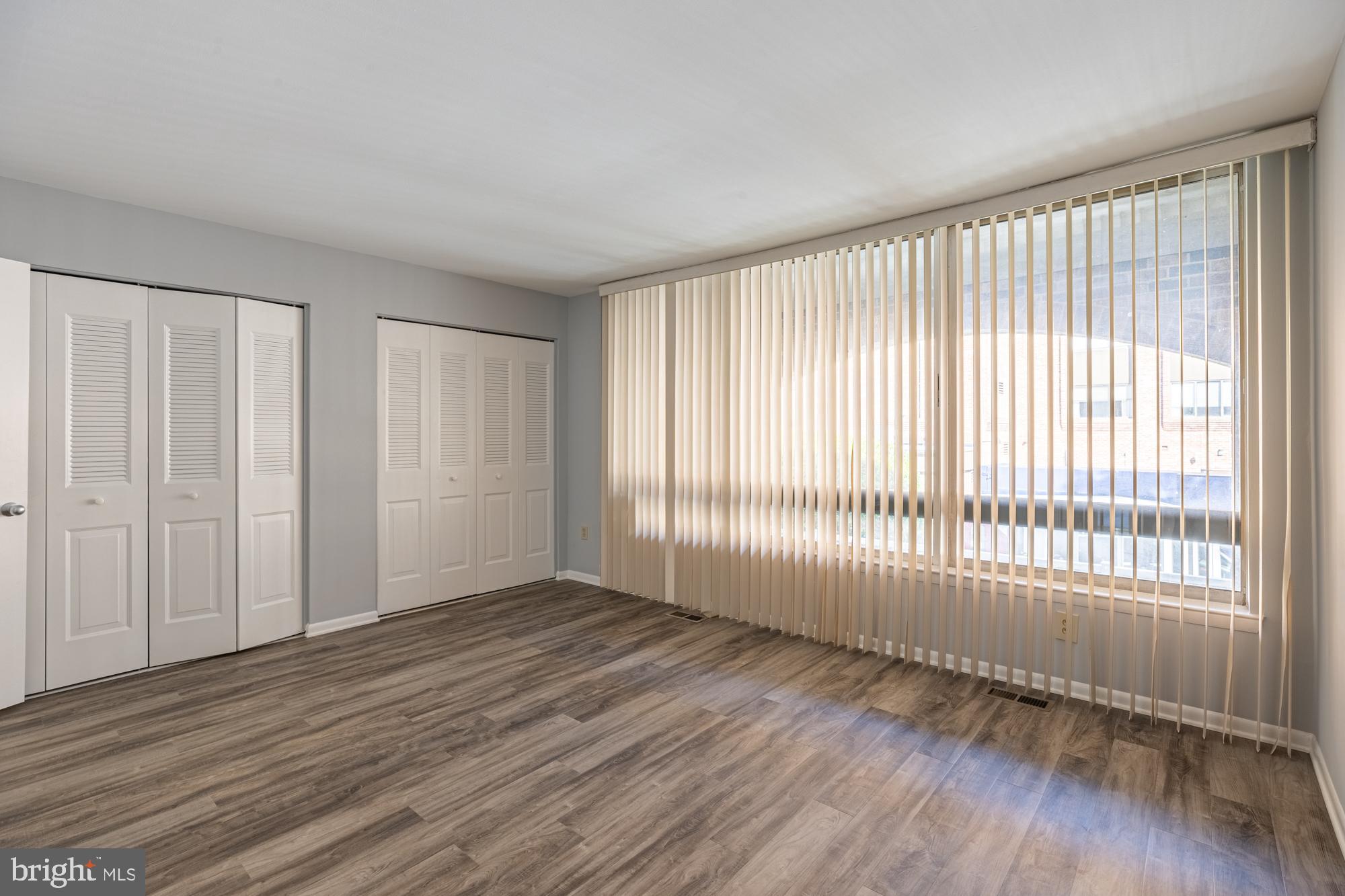 1765 South Hayes Street, Unit A Arlington, VA 22202 - Photo 9 of 21 a view of an empty room with wooden floor and a window