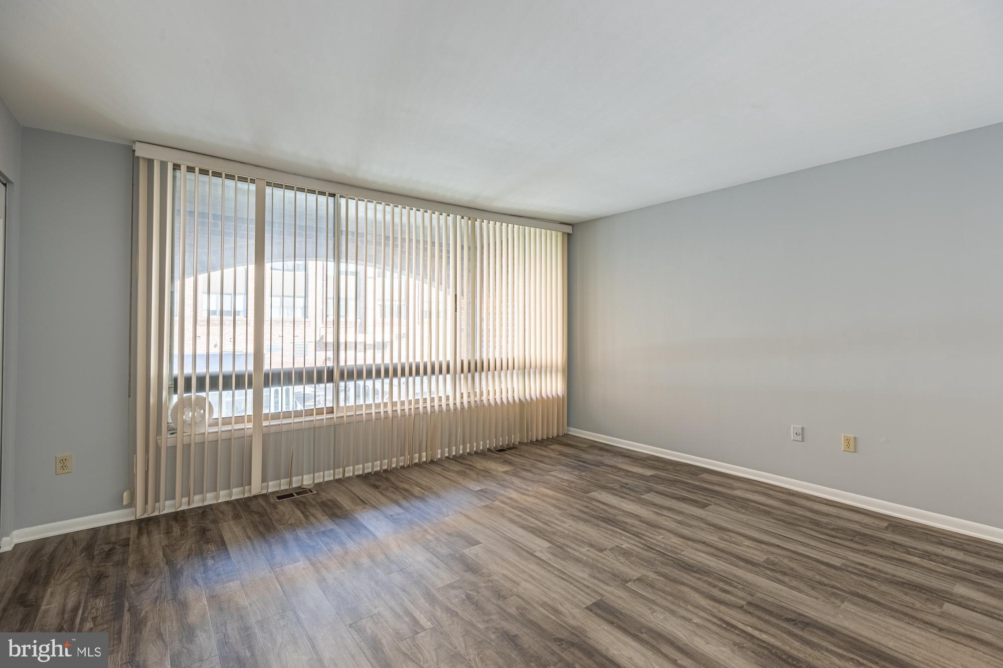 1765 South Hayes Street, Unit A Arlington, VA 22202 - Photo 10 of 21 a view of an empty room with wooden floor and a window