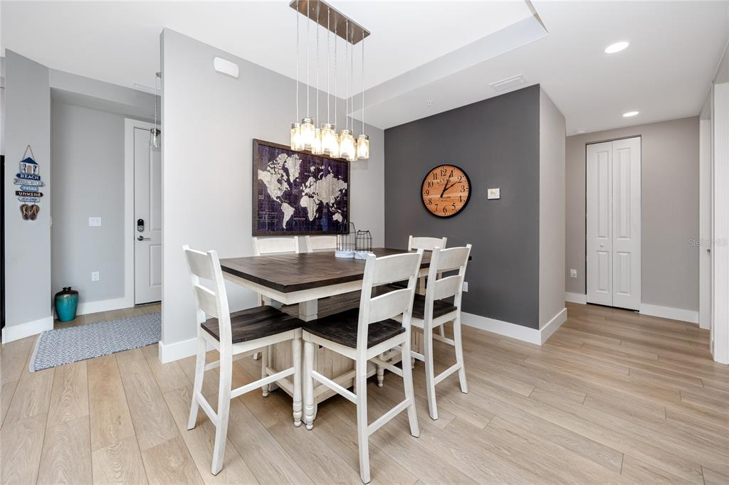 300 150th Avenue, Unit 502 Madeira Beach, FL 33708 - Photo 15 of 52 a view of a dining room with furniture and wooden floor