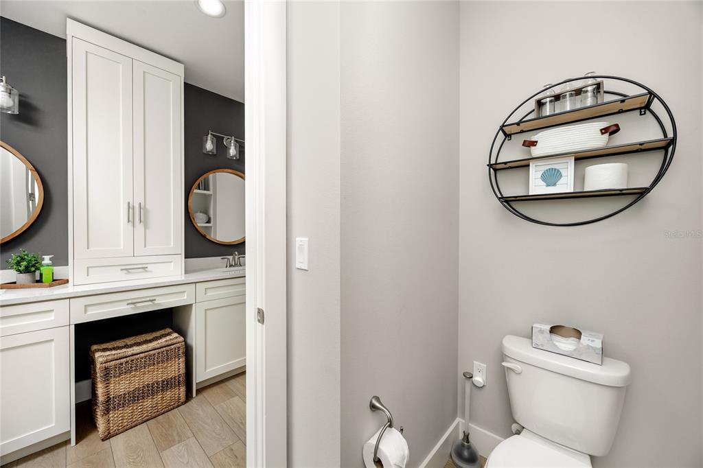 300 150th Avenue, Unit 502 Madeira Beach, FL 33708 - Photo 32 of 52 a bathroom with a toilet a sink and mirror