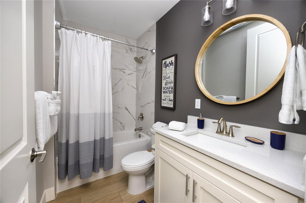 300 150th Avenue, Unit 502 Madeira Beach, FL 33708 - Photo 34 of 52 a bathroom with a sink a toilet and a mirror