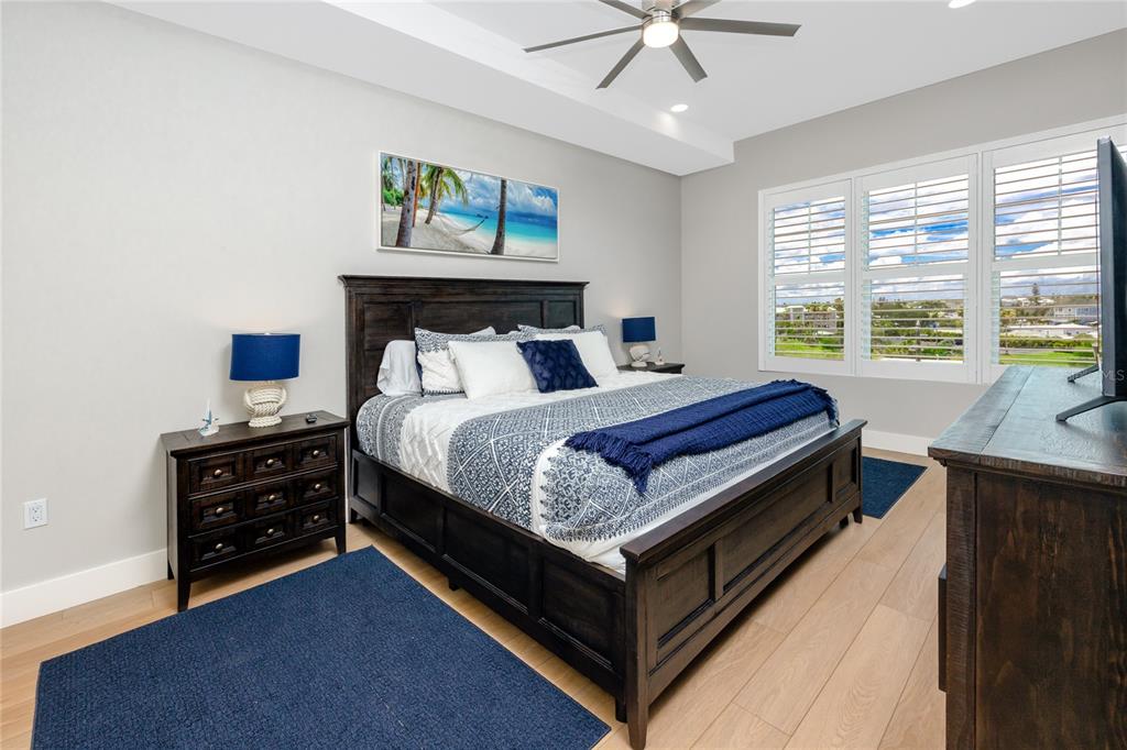 300 150th Avenue, Unit 502 Madeira Beach, FL 33708 - Photo 35 of 52 a bed room with a bed and a chandelier