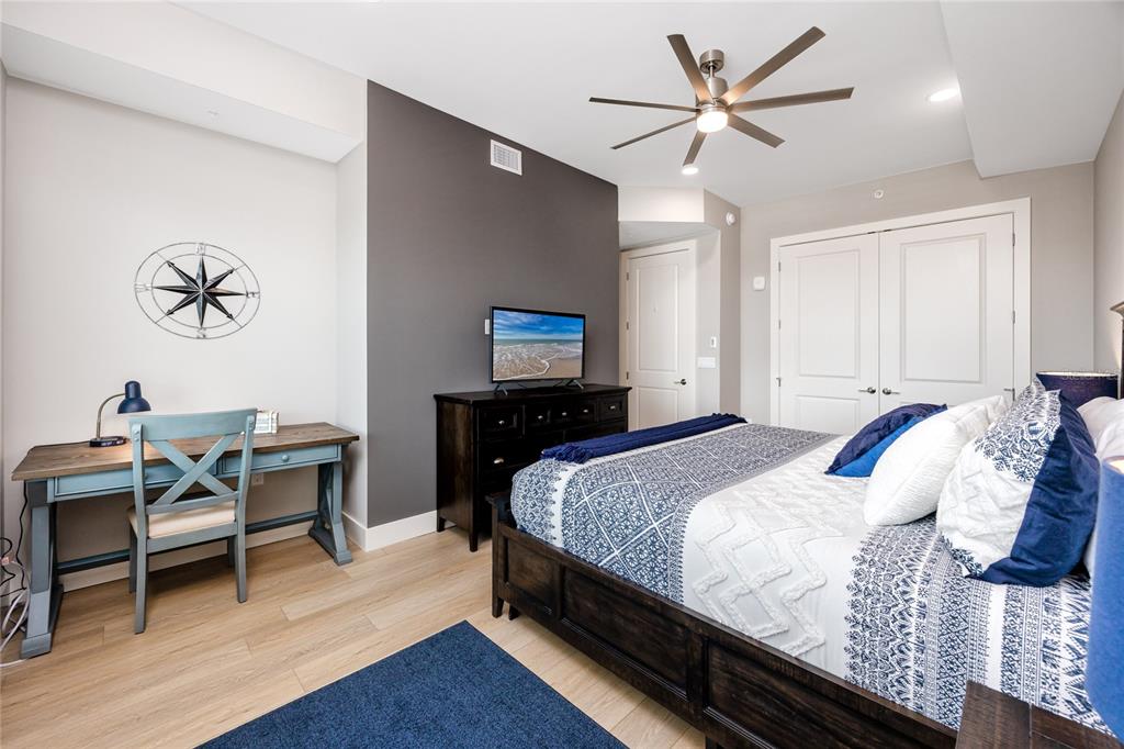 300 150th Avenue, Unit 502 Madeira Beach, FL 33708 - Photo 36 of 52 a bedroom with a bed and a table in it