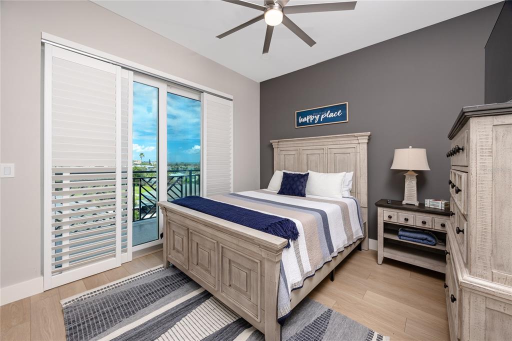300 150th Avenue, Unit 502 Madeira Beach, FL 33708 - Photo 38 of 52 a bedroom with bed and a large window