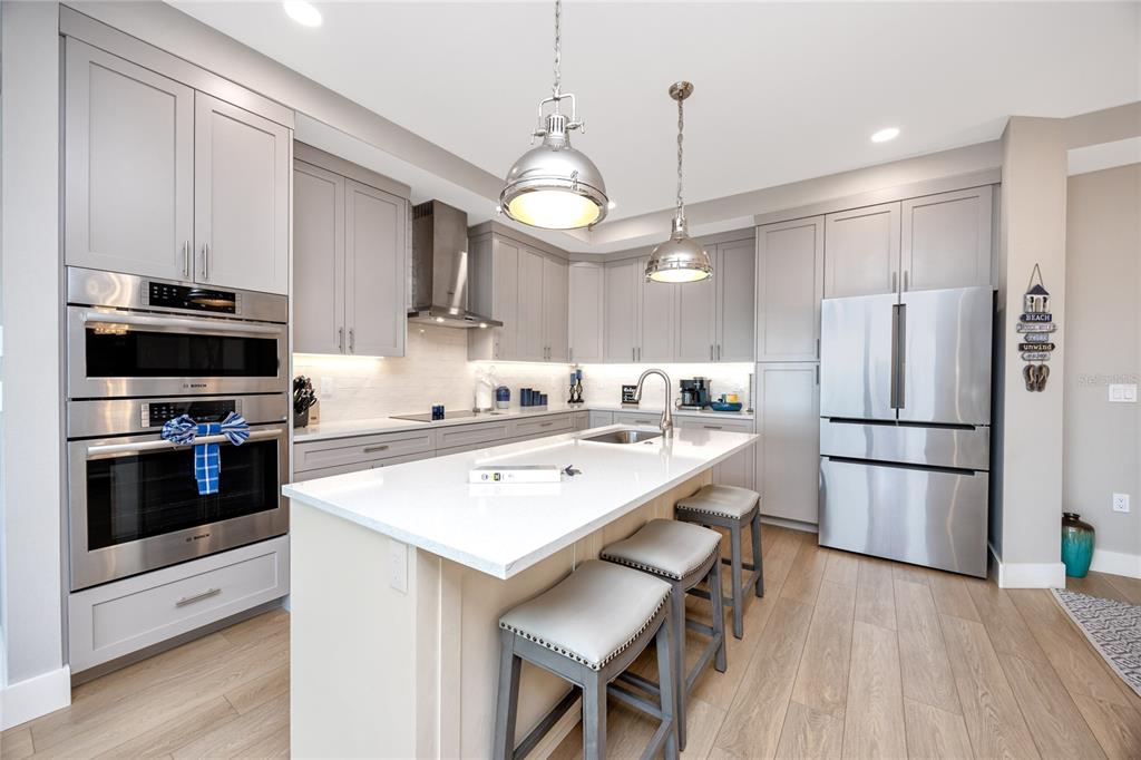 300 150th Avenue, Unit 502 Madeira Beach, FL 33708 - Photo 6 of 52 a kitchen with a sink stainless steel appliances and white cabinets