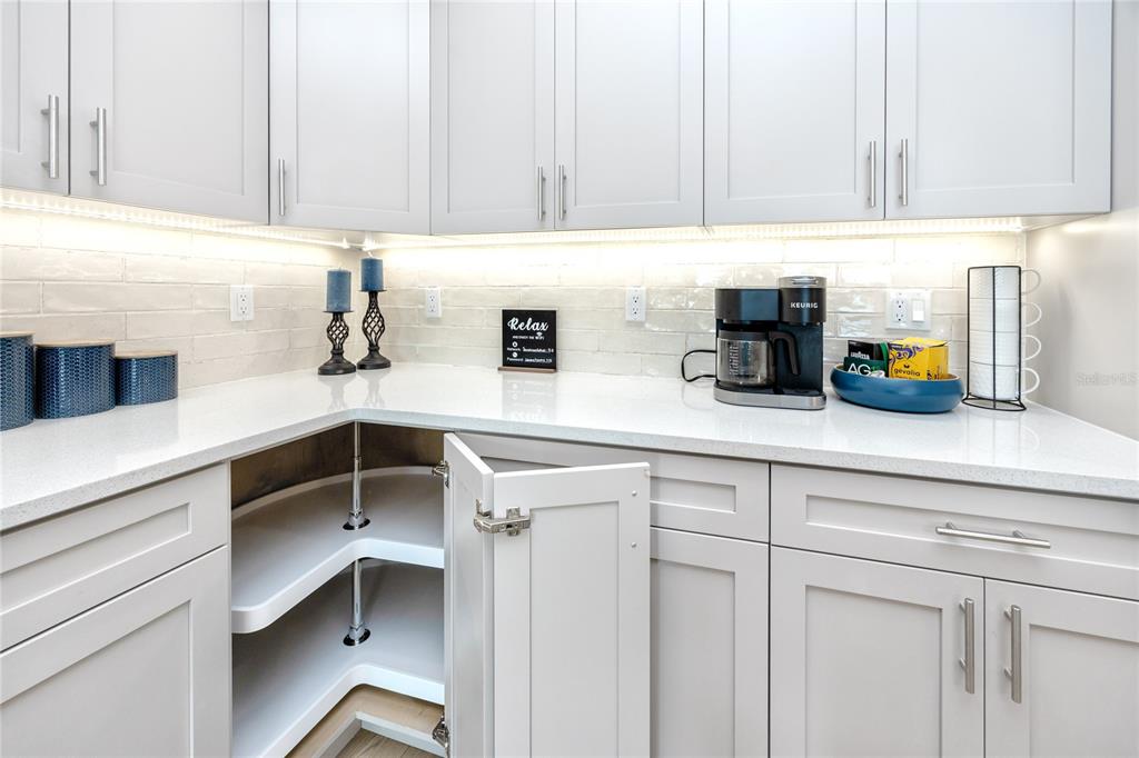300 150th Avenue, Unit 502 Madeira Beach, FL 33708 - Photo 9 of 52 a kitchen with a sink and cabinets