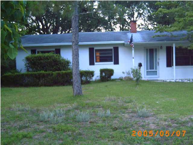 420 Edge Avenue Valparaiso, FL 32580 - Photo 2 of 3 a front view of a house with a garden and yard