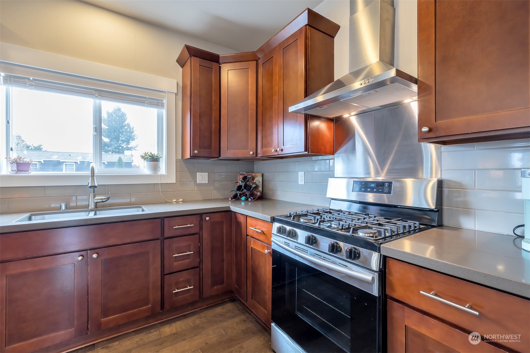 13508 6th Avenue Southwest Burien, WA 98146 - Photo 11 of 39 a kitchen with stainless steel appliances granite countertop a sink a stove and a wooden cabinets