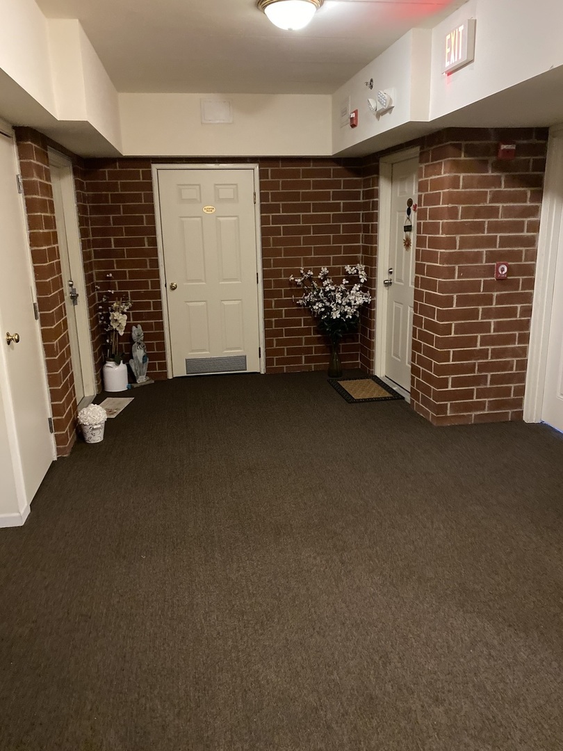 2321 183rd Street, Unit 101 Homewood, IL 60430 - Photo 2 of 27 a view of an empty room with closet and brick wall