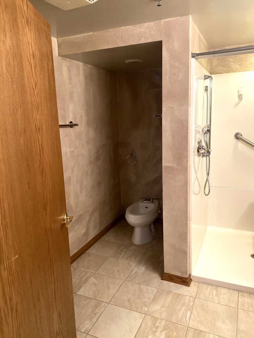 2321 183rd Street, Unit 101 Homewood, IL 60430 - Photo 19 of 27 a bathroom with a toilet and a shower